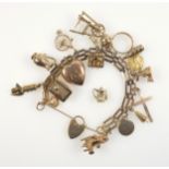 9ct. gold gate-link charm bracelet with 17 9ct. charms including a safe with opening door