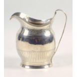 George III silver oval baluster cream jug with engraved decoration, monogram ?????, and scroll