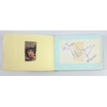 An autograph book with assorted signatures and messages from celebrities to include Peter Cook and