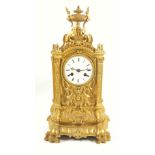 A 19th century French ormolu mantel clock, the circular enamel dial with roman numerals to a two