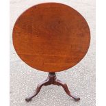 George III mahogany tripod table, the one piece tilt top on a barrel turned tapering support on