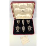 George V silver 6 piece cruet comprising a pair of circular salt cellars, with blue glass liners,