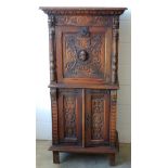 Late 19th century Flemish carved oak cabinet with mask, shell, scroll and figural decoration, the