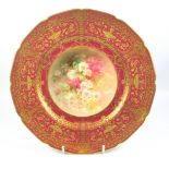 Royal Doulton cabinet plate, painted to the centre with a floral spray by Percy Curnock, within