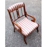 A Regency style mahogany, boxwood line inlaid elbow chair, the curved back with fan inlaid pierced