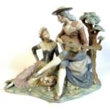 Lladro, porcelain figure group of a male musician alongside his female companion, a basket of