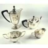 George V silver four piece tea and coffee set of shaped oval design comprising a teapot, cream jug