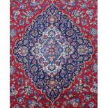Persian carpet, the madder and indigo field with an anchor medallion, spandrels and all-over