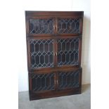 A pair of 1930?s oak sectional bookcases with three pairs of lead glazed panelled doors, H. 137.5