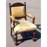 An early 20th century stained oak framed elbow chair, the leather upholstered back, seat and arm