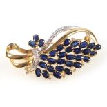 Yellow and white metal openwork brooch/pendant of floral spray form, set 30 sapphires and 22