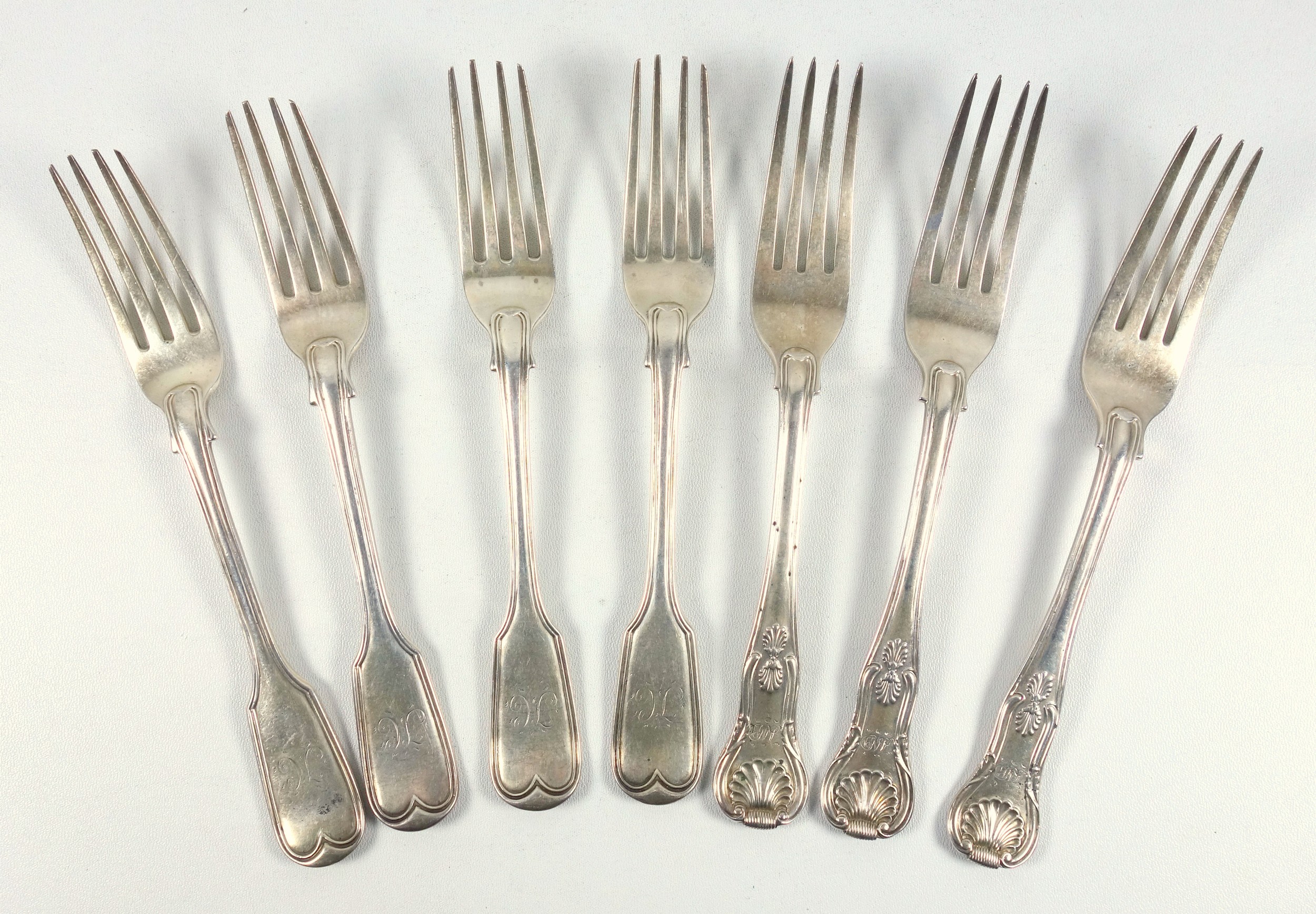 Three William IV silver table forks, with a shell handle and monogram, London 1834, and 4