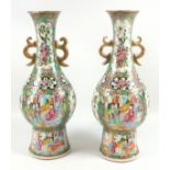Late 19th century pair of Cantonese famille rose baluster shaped double handled vases, painted