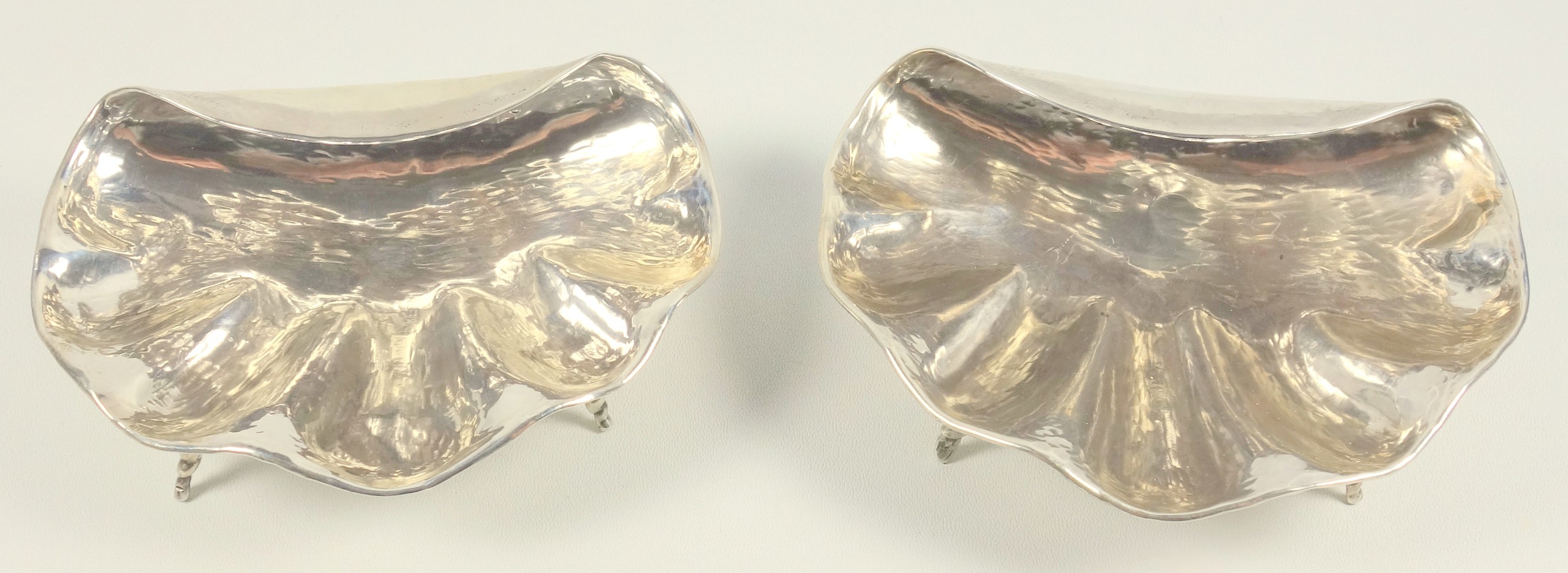 Pair of Peruvian white metal shell shaped dishes, each on 3 tapering shell legs, by J Tavara,