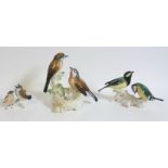 Group of 2 Karl Ens birds perched with a nest, painted in naturalistic hues, H 15cm, and 2 smaller