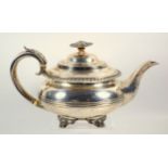 George IV silver teapot of compressed circular form, with a gadrooned rim and gauntlet crest,