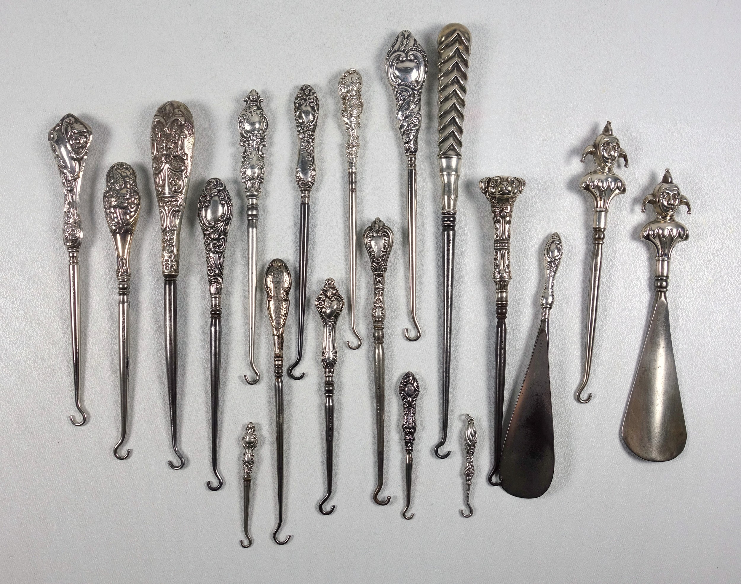 Collection of 14 late Victorian and later silver handled button hooks including one with a double