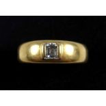 Yellow metal ring set emerald cut diamond, 4 x 3.5mm, stamped “18K”, gross 7.3grs