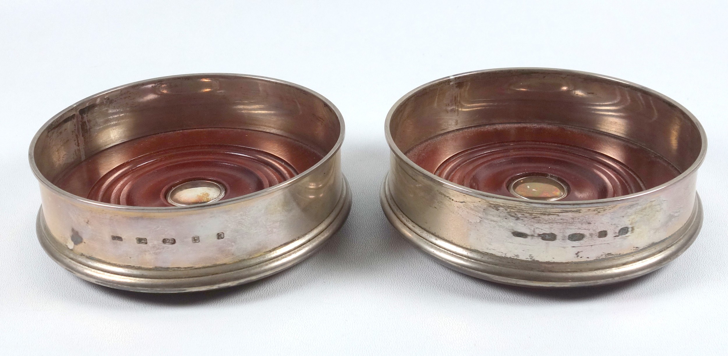 Pair of silver circular coasters, each with a turned mahogany base, by J Bull Ltd, London 2009, D