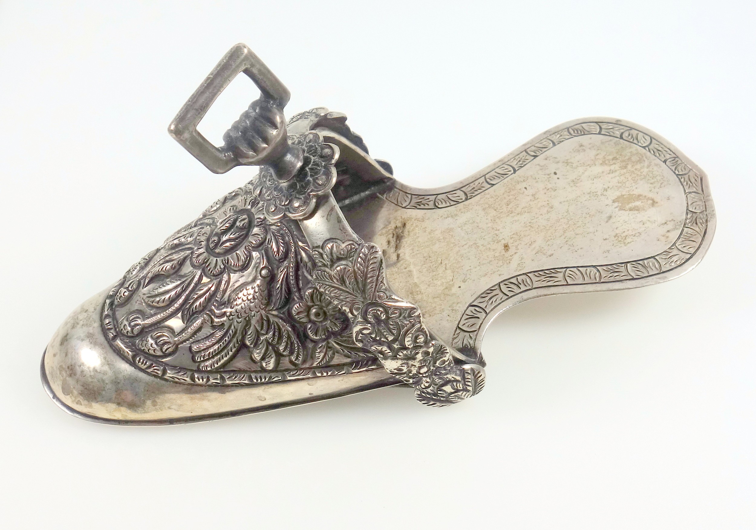 South American ladies white metal stirrup in the form of a shoe, embossed with 2 exotic birds, fruit