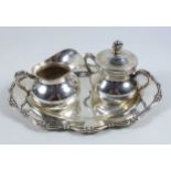 Peruvian white metal baluster cream jug and sugar basin with cover and scroll handles, on an oval