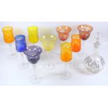Set of four Bohemian coloured hock style drinking glass, a similar set of five coloured drinking