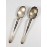 Pair of contemporary Arts & Crafts silver spoons, each with a deep bowl and waisted flat handle,