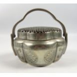Chinese Paktong cricket cage in quadrafoil form, with pierced lid, swing handle and engraved