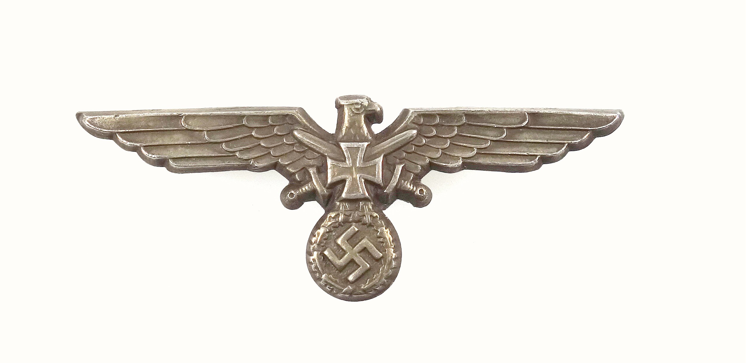 WW2 German Eagle and crossed swords cap badge, the reverse with three metal prongs and stamped 3