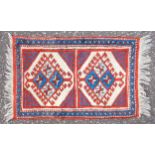 Turkey rug, the field with 2 hooked lozenges within a zig-zag border, 90 x 59cm, and a mat (2)