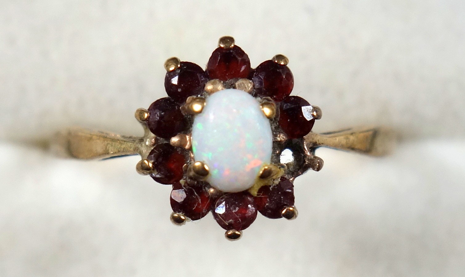 9ct gold opal and garnet floral ring, gross 1.9 grams (1 garnet missing) Necklaces, brooches and