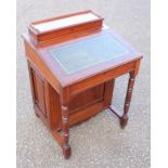 Late Victorian walnut Davenport with a hinged sloping top and rising back disclosing stationery