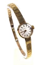 Certina ladies 9ct gold bracelet watch with a circular white dial with baton markers enclosing a