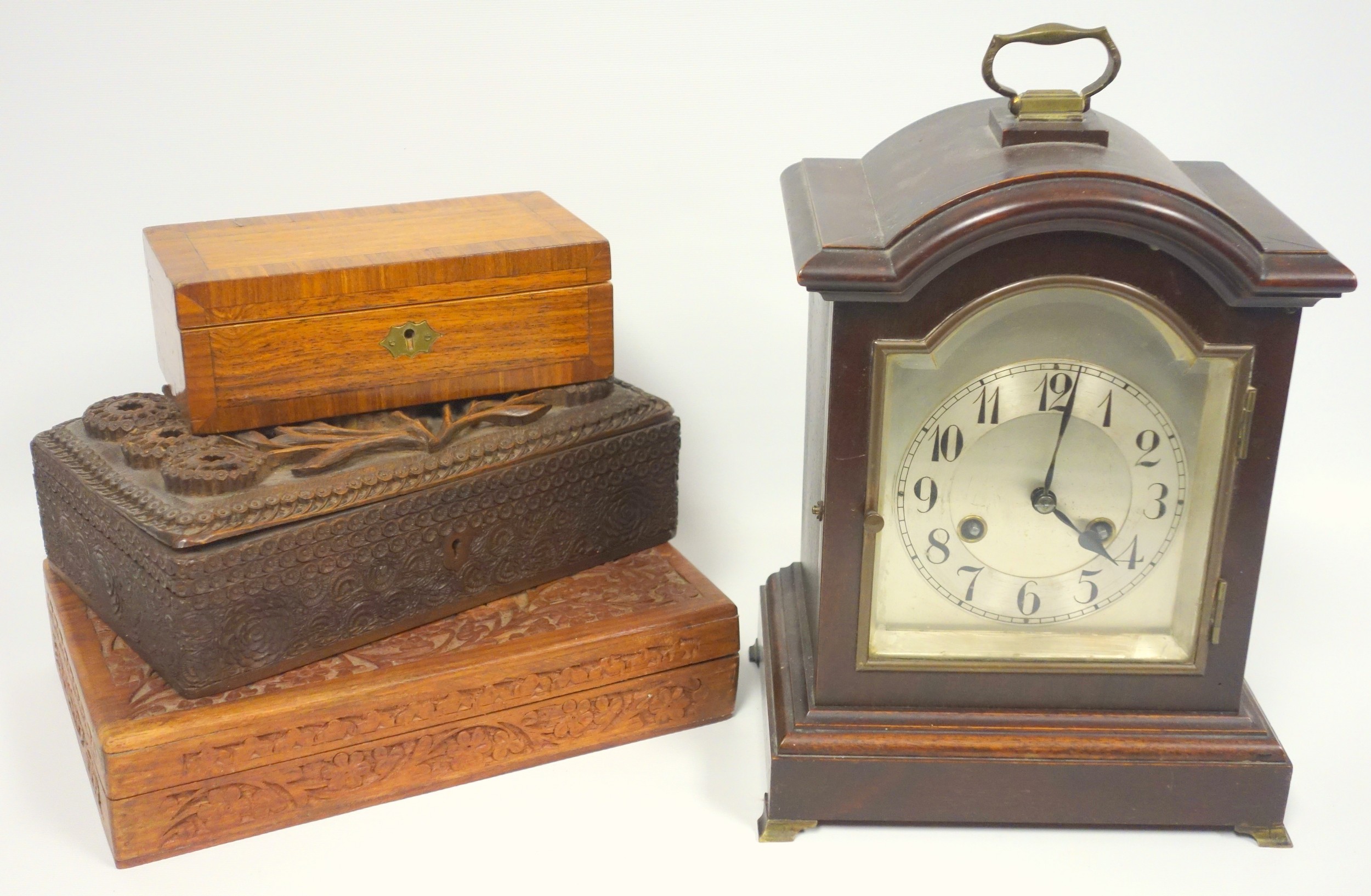 Early 20th century German mantel clock with a silvered arched dial, black Roman numerals,