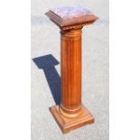 Italian walnut torchere with an inset veined marble square top, on a fluted cylindrical column,