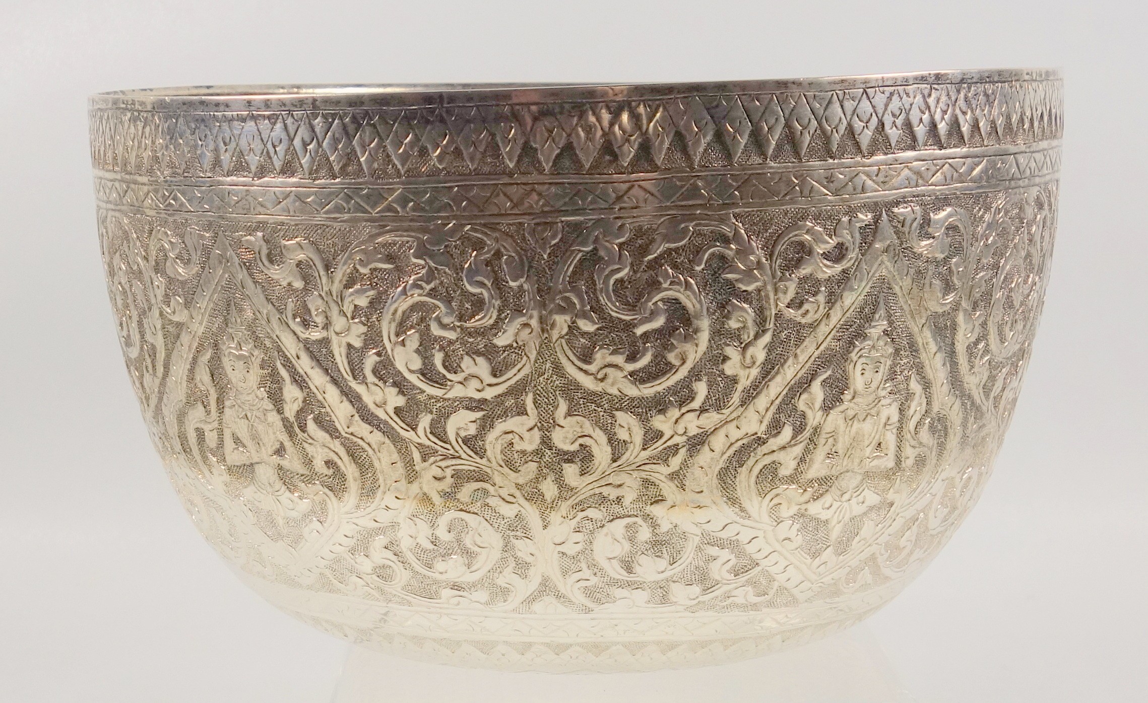 Burmese white metal circular bowl embossed with Buddhas and scrolling floral decoration, D 19cm, - Image 2 of 4