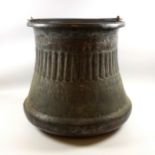 A large, bell-shaped copper cooking pot, with an iron handle and fleur-de-lys decoration. H33.5cm