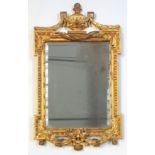 Late 19th century neoclassical rectangular carved gilt wood bevelled mirror, with surmounted with an
