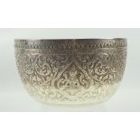 Burmese white metal circular bowl embossed with Buddhas and scrolling floral decoration, D 19cm,