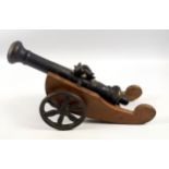 A bronze model of a Dutch East India cannon, possibly a signal cannon, mounted on a wooden carriage,