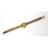 Longines 18ct gold Ladies wristwatch with a circular dial and baton markers, enclosing a side wind