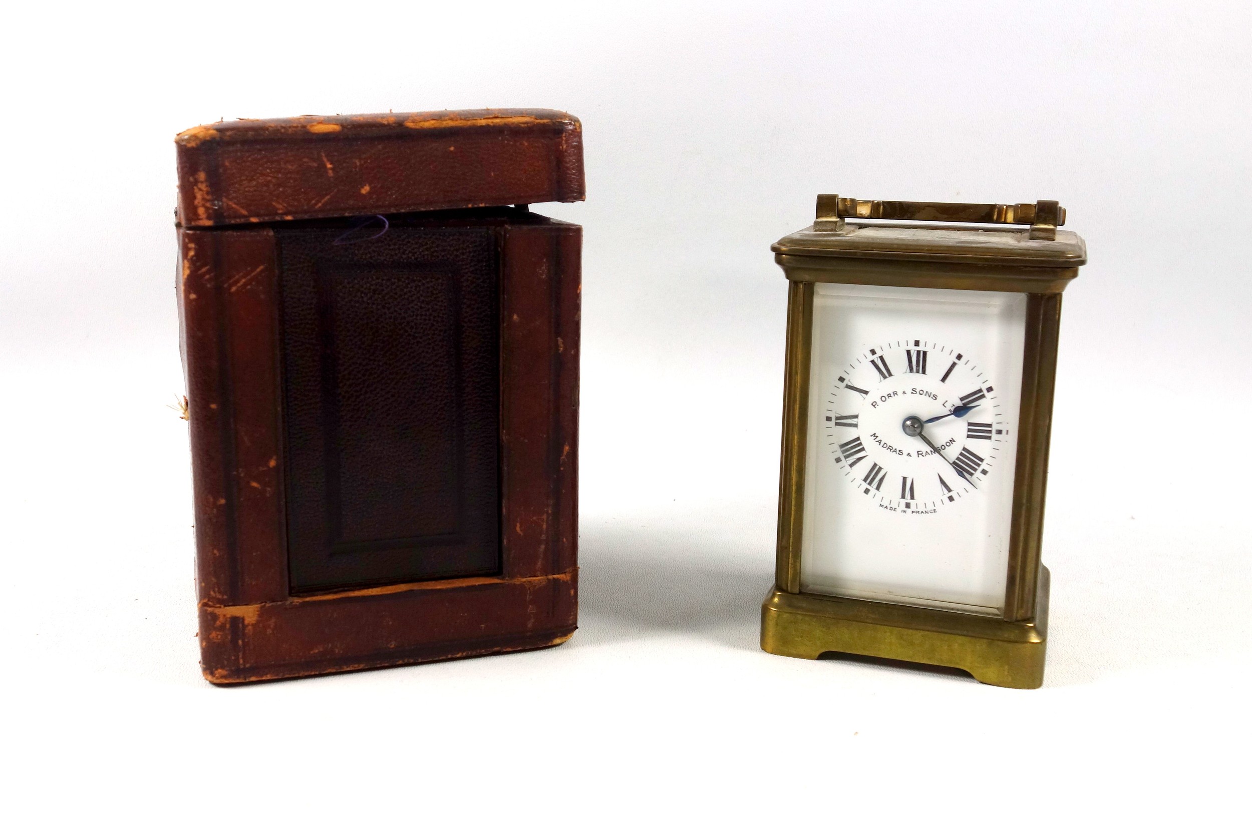 An early 20th century brass carriage timepiece with white Roman numeric dial, marked "P. Orr &