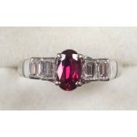 White metal ring set heat treated ruby and 4 baguette diamonds, stamped 585, gross 3.3grs, size L1/2