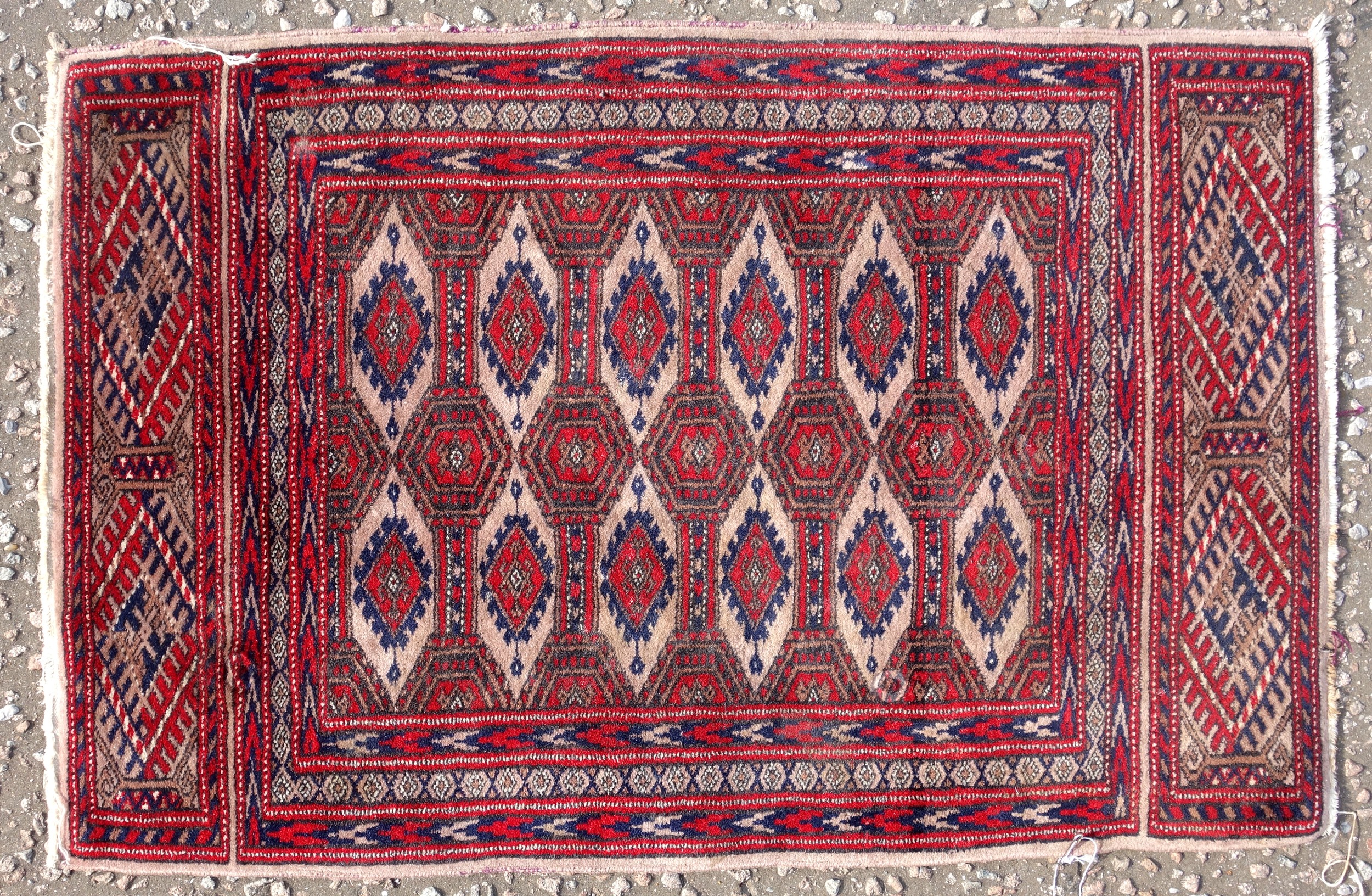 Persian Bokhara pattern rug, the madder field with 2 rows of hexagons and stylised floral