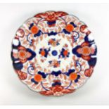 Late 19th Century Japanese porcelain fluted saucerdish with painted blue and red Imari floral
