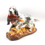 Royal Doulton figure of an English setter carrying a pheasant, HN 2529, 22cm x 27.5cm