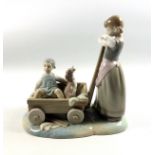 Lladro porcelain group of a girl with a girl and dog sitting in a cart, W.21.5cm