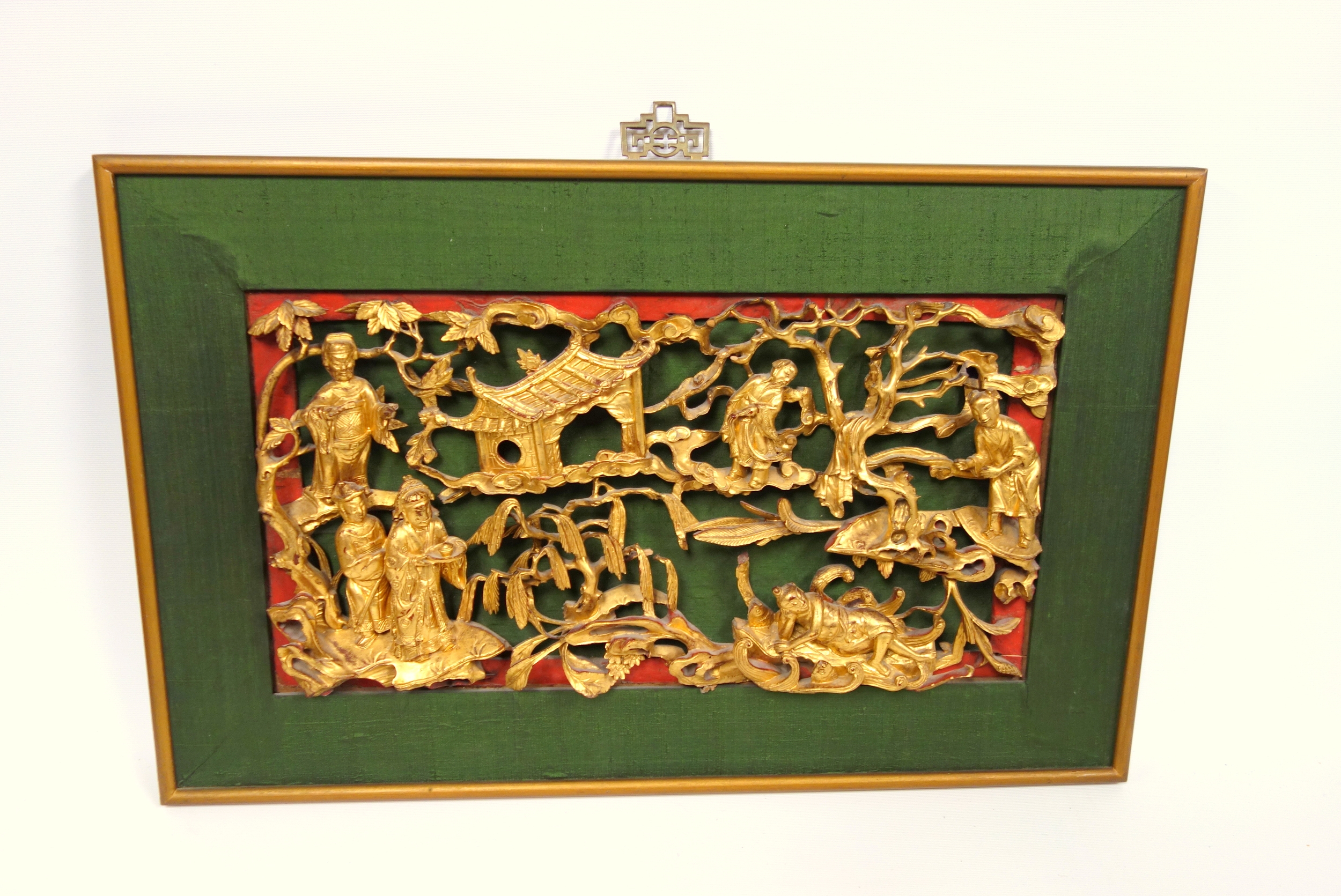 Chinese carved and pierced wood panel with figures, buildings, flowers and foliage, 23.5 x 4.5cm, (