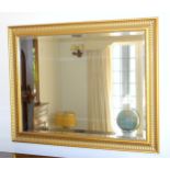 Large rectangular bevelled mirror in a giltwood and painted dentil frame with beaded and rope