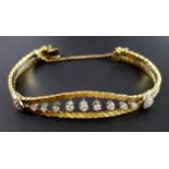 Yellow metal bracelet with 9 individually set diamonds and brilliants, stamped "18" and ".750",